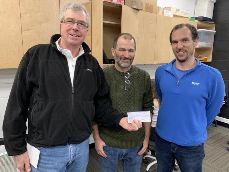 Boothbay Harbor Region Chamber of Commerce’s Adopt-a-Tree fundraiser raised $600 for Boothbay Region Education Foundation. On Jan. 11, volunteer Tom Minerich, left, presented high school STEM teachers Chip Schwehm, center, and Ben Powell, right, with a $600 check from tree sales. BILL PEARSON/Boothbay Register