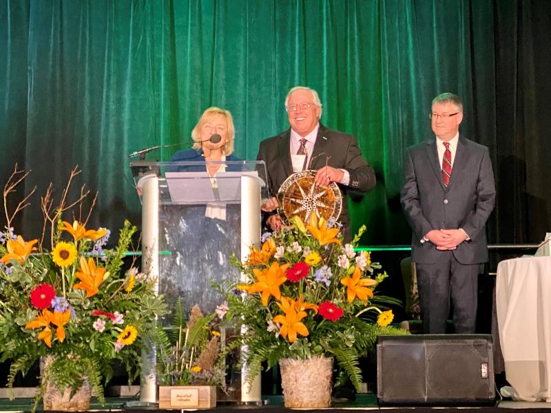 Governor Jane Mills presents the 2023 Maine Office of Tourism’s Governor’s Award for Tourism Excellence to Paul Coulombe in Bangor on March 28. At right is Steve Lyons, Director of the Maine Office of Tourism. Courtesy of Michelle Amero