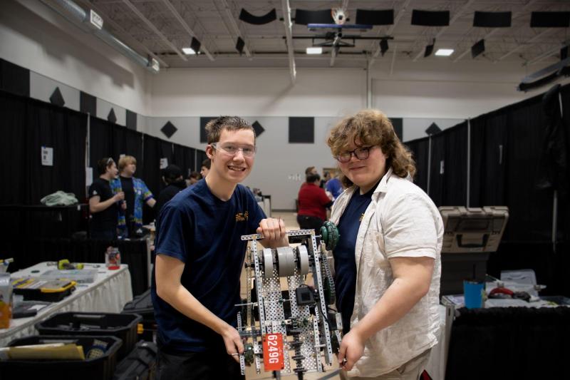 Matthias Fanslau, left, and Everett Howard show off the robot they built and used for the state championship. Sebastian Warren-Burdin photo