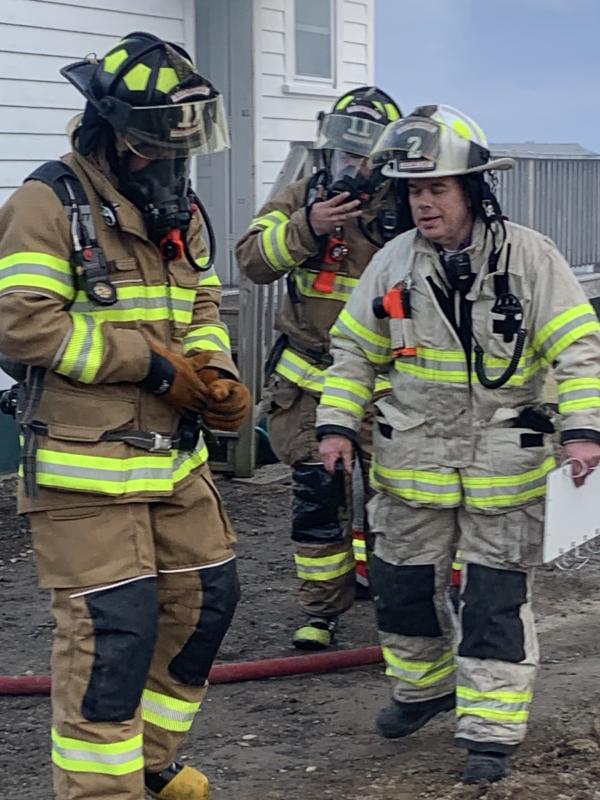 Boothbay Harbor Assistant Fire Chief Glenn Tilton, right, helps a couple of firefighters. KEVIN BURNHAM/Boothbay Register