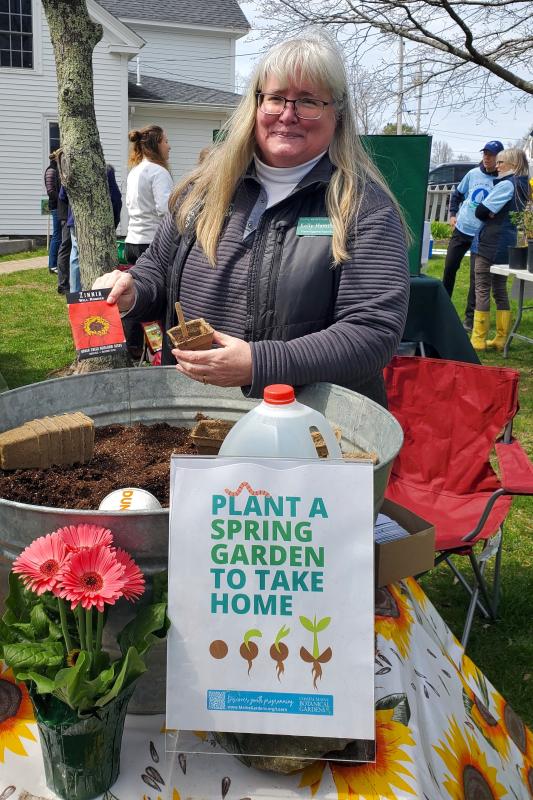 Kelly Hamilton from Coastal Maine Botanical Gardens shows off one of the starter seed kits being given away. FRITZ FREUDENBERGER/Boothbay Register