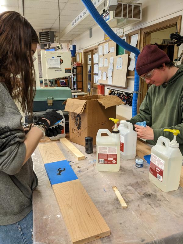 Students work with epoxy for emblems. CANDI JONETH/Boothbay Register