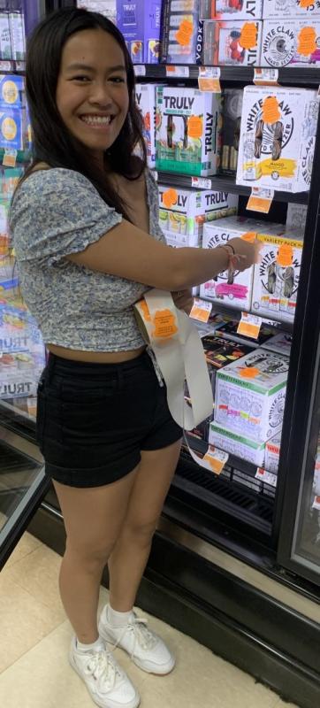 Ariel Alamo was one of the Student Health Advisory Board members who volunteered to place labels on alcohol sold in local stores to warn adults about laws covering underage drinking. BILL PEARSON/Boothbay Register