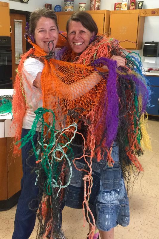 BRES art teacher Jessica Nadeau, left, and artist Pamela Moulton wear part of the art. FRITZ FREUDENBERGER/Boothbay Register