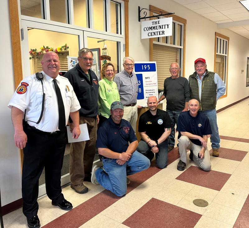 Meeting at the Community Center for support of its Emergency Sign Program are, from left, kneeling: Chief Nick Upham BHFD; Chief Doug Snyder BHPD; Officer Larry Brown BHPD; standing: Chief Dan Gardner BRAS; Chief Dick Spofford BFD; Supervisor Tara Dow Lincoln County Communications; Shawn Lewin board president; Community Center, Dwight Lewis, Emergency Sign maker; and Steve Gaudette SPD. Courtesy photo