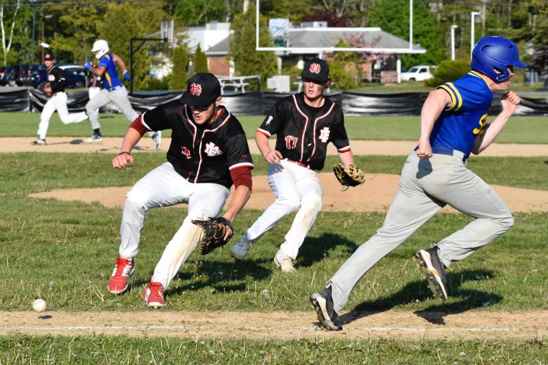 Seahawk Henry Putnam rushes for first base while Luke Morley tried to take third against Hall-Dale May 26. FRITZ FREUDENBERGER/Boothbay Register