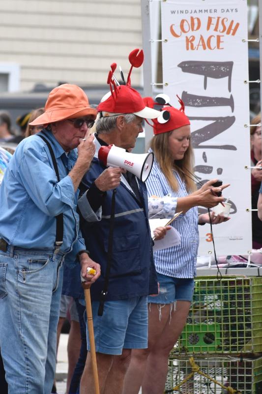 Captain Rusty Court blows the whistle to start a race. Race sponsor Jack Herger is at right. FRITZ FREUDENBERGER/Boothbay Register