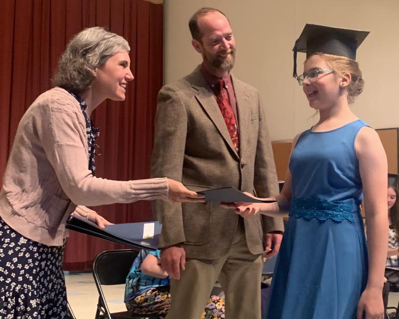 Graduate Jillian Murray receives her sixth grade diploma from Edgecomb School Committee member Nichole Price and Principal Tom Landberg. BILL PEARSON/Boothbay Register