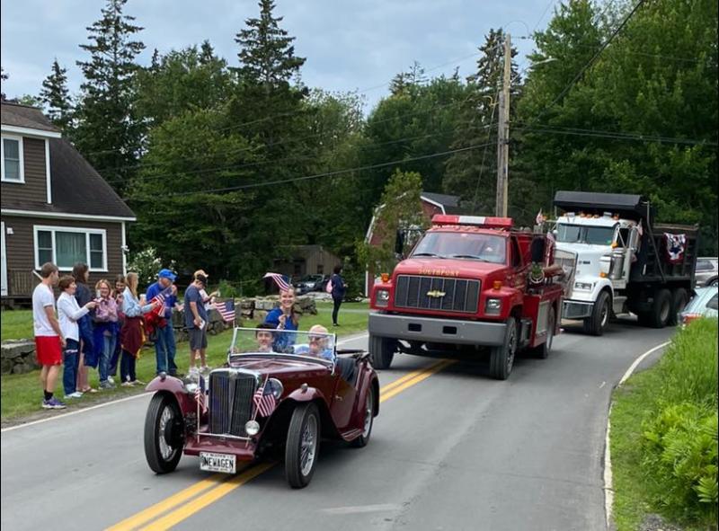 The Meserves’ MG and some town trucks. Courtesy of Helen Meserve