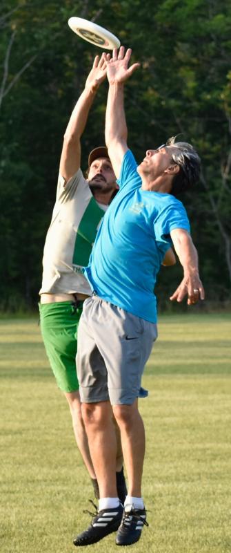 Ben Snead, in blue, and Benjamin Snark vie for the Frisbee. FRITZ FREUDENBERGER/Boothbay Register