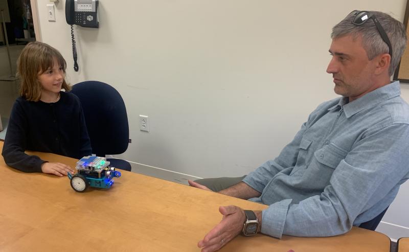 Lyla Joyce shows her father, Bill Joyce, how the robot works which she built last month at the National Youth Leadership Forum held in Waltham, Massachusetts. BILL PEARSON/Boothbay Register
