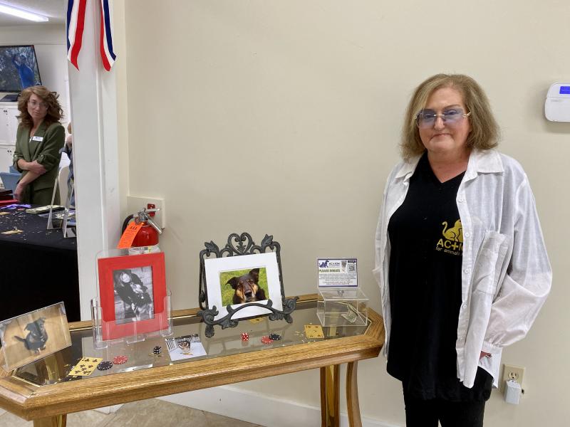 Giselle Armstrong, founder of Action for Animals Maine (AFAM), poses with photos of Butterball, the dog who inspired her to create the organization. ISABELLE CURTIS/Boothbay Register