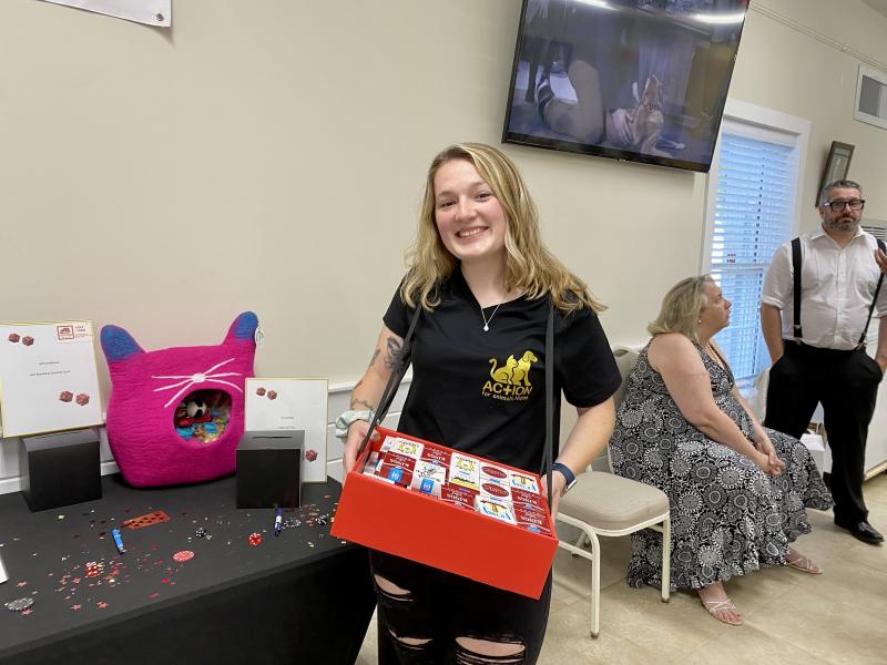 Kayla Lewis, who helps run AFAM social media accounts, passes out candy cigarettes to visitors. ISABELLE CURTIS/Boothbay Register