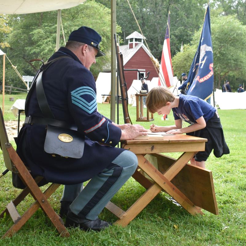 Preston Parise, 7, enlists. According to the enlisting officer, Parise was standing on a sign that read “18,” so, technically, he was “over 18” when he joined the Army. FRITZ FREUDENBERGER/Boothbay Register
