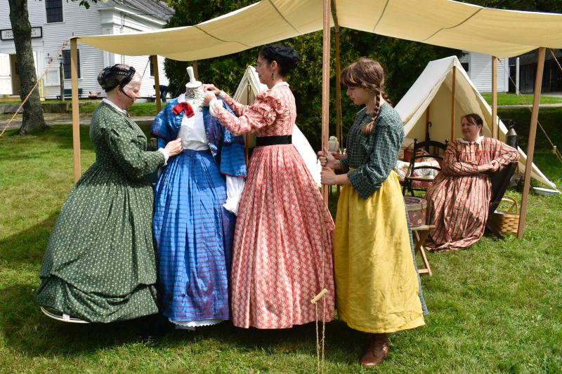 Carolyn Lawson, left, leads a talk on women’s fashion with other civilian volunteers. FRITZ FREUDENBERGER/Boothbay Register