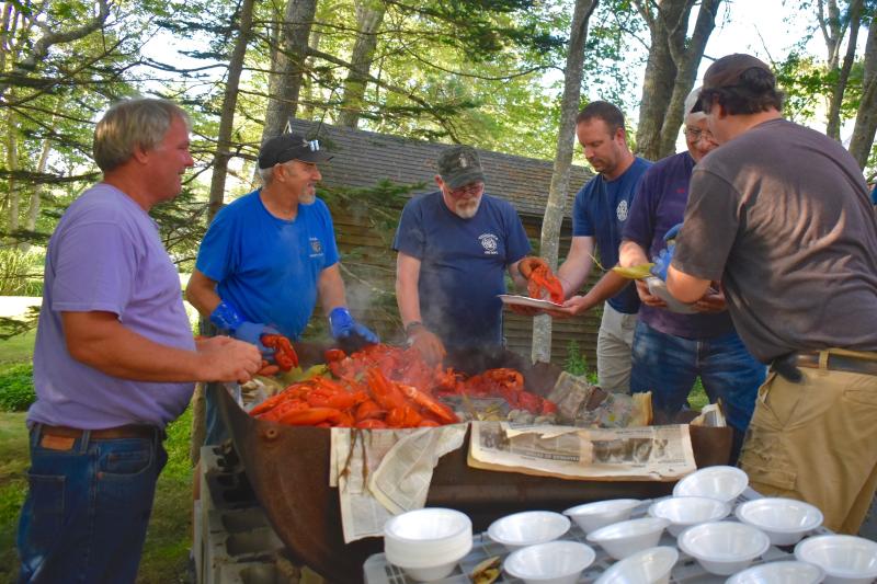 Members of the Boothbay Fire Department get their share of the lobster bake. FRITZ FREUDENBERGER/Boothbay Register
