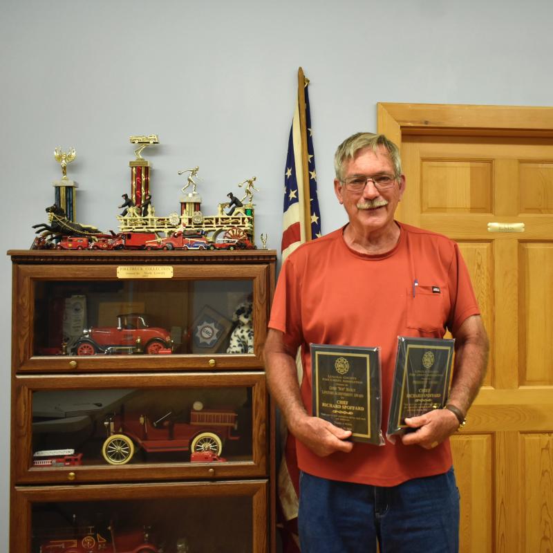 Former Boothbay Fire Chief Richard Spofford poses with his two awards from the the Lincoln County Fire Chiefs Association meeting Aug. 16. FRITZ FREUDENBERGER/Boothbay Register