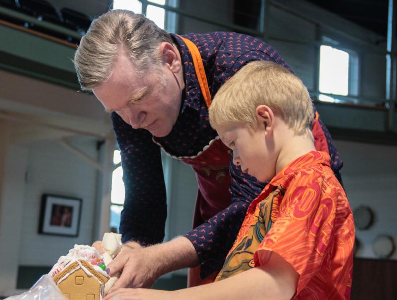 Gingerbread construction 101: Kevin Kiley assists an aspiring architect. Robert Mitchell photo