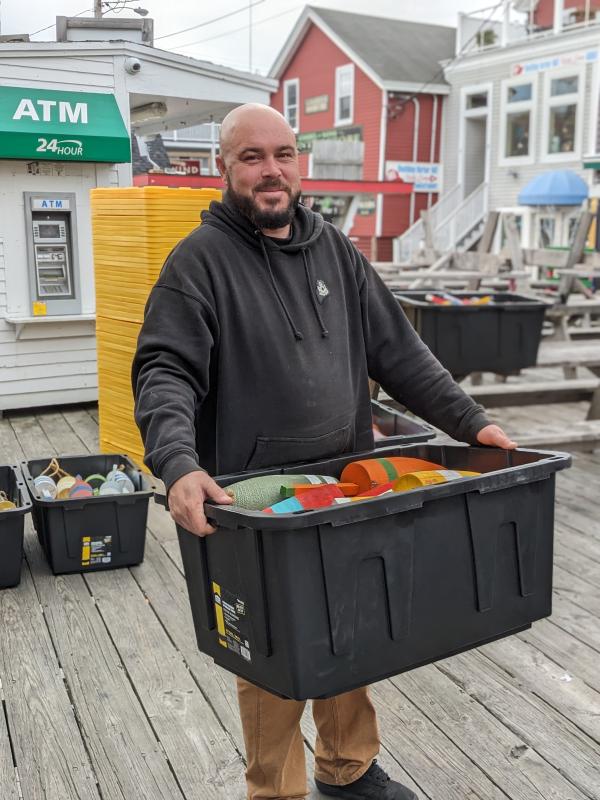 Eric Gimbel enjoys constructing the buoy tree community event at pier one Nov. 4. CANDI JONETH/Boothbay Register