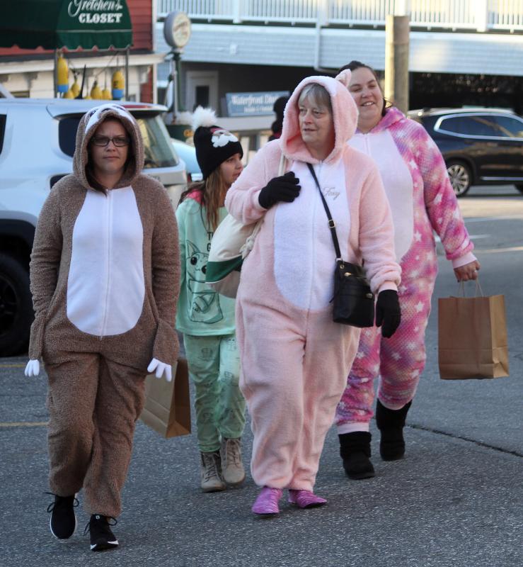 These Early Birds are sporting jammies from the warm and cozy line of morning shopping wear! File photo