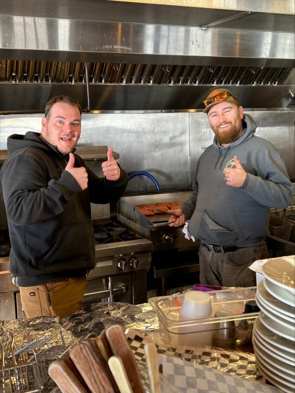 Nick Christopher, left, and Riley Mitchell helping out on the grill. Jennie Mitchell photo
