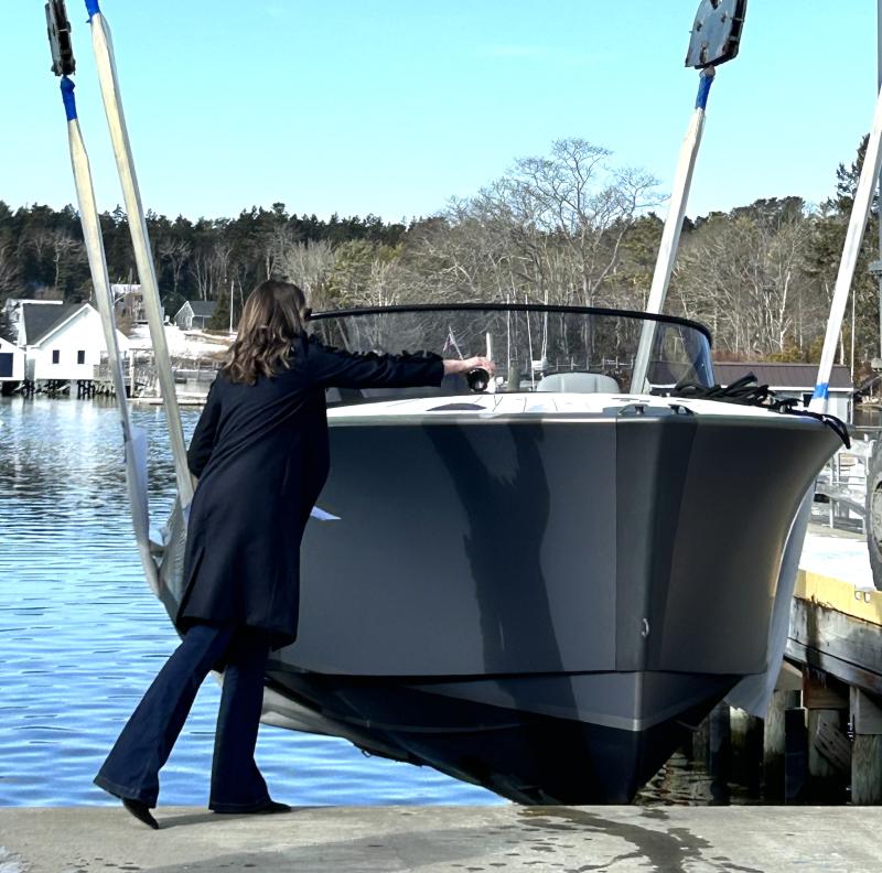 Ariel Thompson, wife of Design and Engineering Manager Nate Thompson, christens LION with the traditional splash of champagne. JENNY BENNETT/Boothbay Register