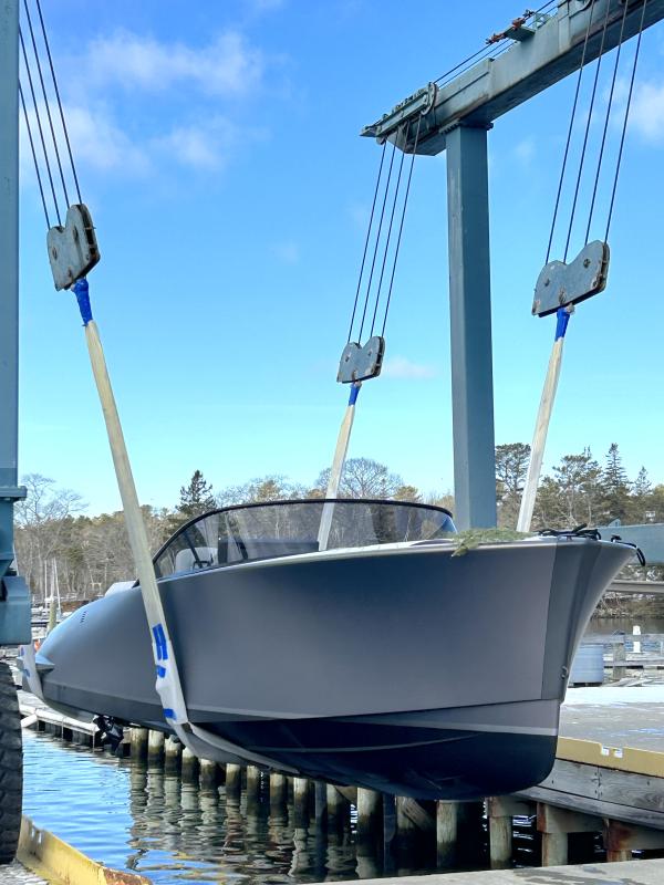 LION in the slings at Hodgdon Yacht Services waiting to be lowered into the water for the first time. The branch was laid on the foredeck during the christening ceremony and signifies a prayer that LION should always return safely to shore. JENNY BENNETT/Boothbay Register