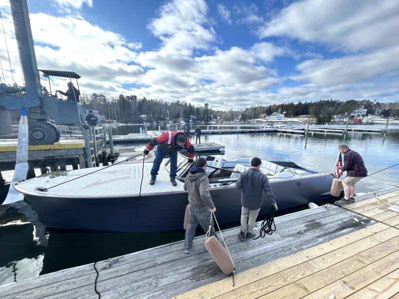 Some of the building crew from Hodgdon Tenders guide LION alongside the float. JENNY BENNETT/Boothbay Register