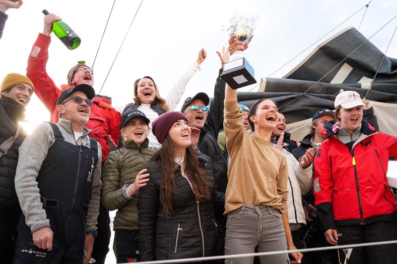 Cole Brauer triumphantly raises her trophy after placing second in the Global Solo Challenge. Alvaro Sanchis photo