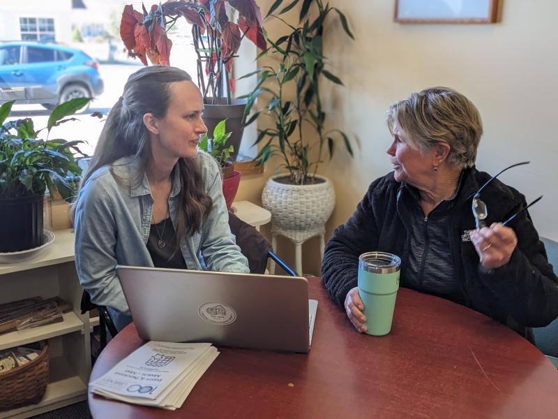 Bethany Schmidt, left, and Lee Corbin of the Community Center discuss pros and cons of the online web authoring tools Wix and Word Press. CANDI JONETH/Boothbay Register