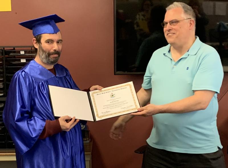 Alternative Organizational Structure (AOS) 98 Superintendent Bob Kahler, right, presents Boothbay Region Adult Education’s newest graduate Jordi Del Rio with a high school diploma March 28 during a ceremony at the high school. BILL PEARSON/Boothbay Register