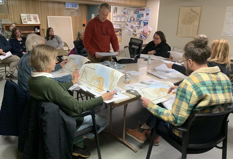 Chris Sieracki, standing, shows the Edgecomb Planning Board plans April 12 for a new home on Cross Point Road. BILL PEARSON/Boothbay Register