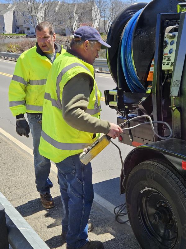 Nick DeGemmis, left, and David Pratt, Boothbay Harbor Sewer District, operating water jetter. Courtesy of Merritt R. Blakeslee