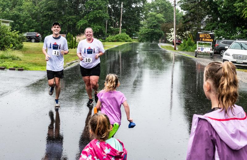 Zach Blanchard, left, and Abigail Estes, second from left, receive an enthusiastic greeting from family members as they complete the Edgecomb 250th Birthday Road Race on June 22. Bisi Cameron Yee photo