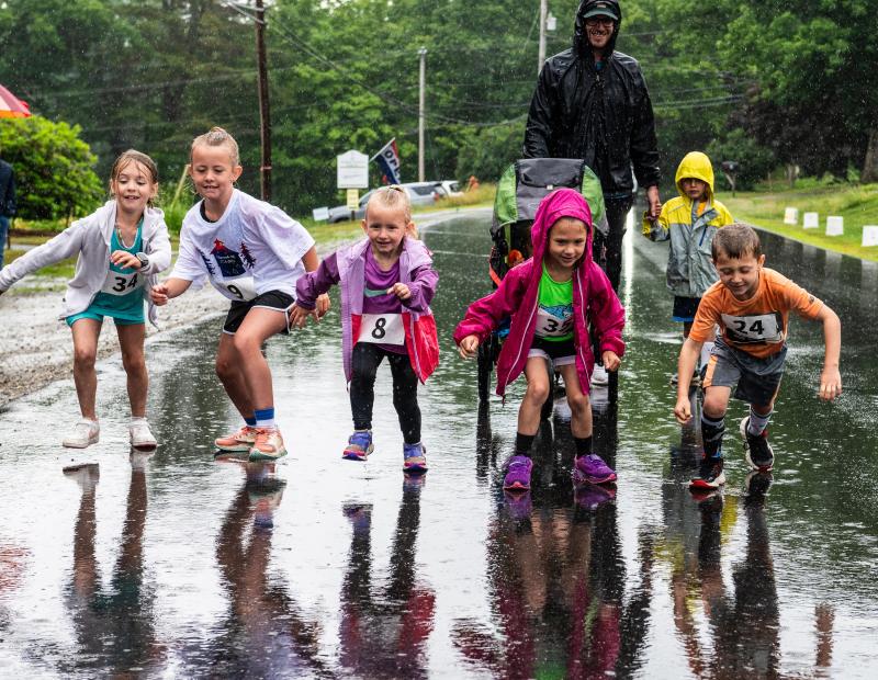 Unfazed by the rain, a group of younger runners start off at a sprint during the kids’ leg of the Edgecomb 250th Birthday Road Race on June 22. The family friendly event catered to all ages and several racers even walked or ran the course with strollers. Bisi Cameron Yee photo