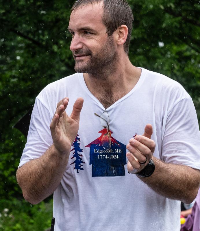 Forrest Carver cheers on runners during the Edgecomb 250th Birthday Road Race on June 22. Carver, a volunteer firefighter as well as a member of the town’s 250th birthday committee, spearheaded the organization of the race. Bisi Cameron Yee photo