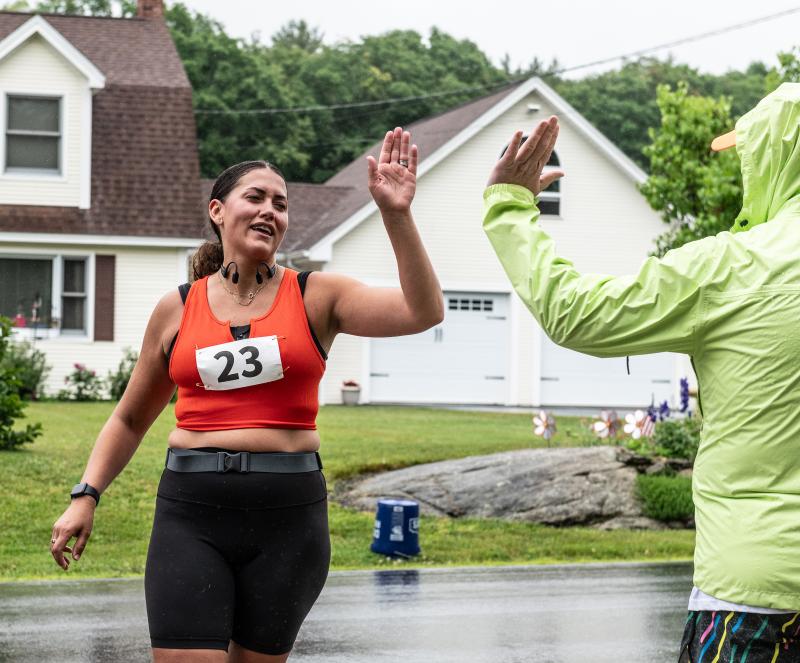 Brianna Buzzell, left, high fives Michael Maxim after finishing the 10K leg of the Edgecomb 250th Birthday Road Race on June 22. Buzzell said she had not planned to run, but came after she was signed up for the race by a friend. Bisi Cameron Yee photo