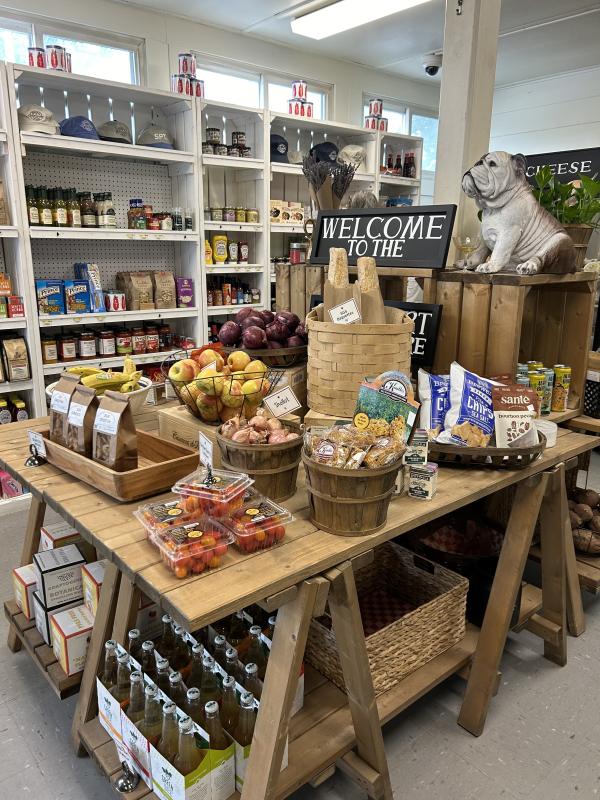 The new grocery table where such goods as SGS crostini and artisan baguettes are to be found alongside the fresh fruit and vegetables. The bulldog has pride of place in honor of the late Mike Beane, friend to all and long-term employee at the General Store. JENNY BENNETT/Boothbay Register