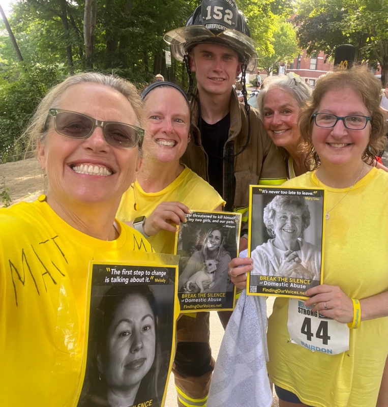 Patrisha McLean, CEO and Founder of Finding Our Voices, FOV board treasurer Nicole Larrabee, firefighter Sam Carpenter, Suzanne Hall, and FOV Operations Manager Mary Kamradt. The posters are part of FOV’s groundbreaking domestic abuse-awareness campaign featuring photo portraits of 45 named Maine domestic abuse survivors. Courtesy of Patrisha McLean