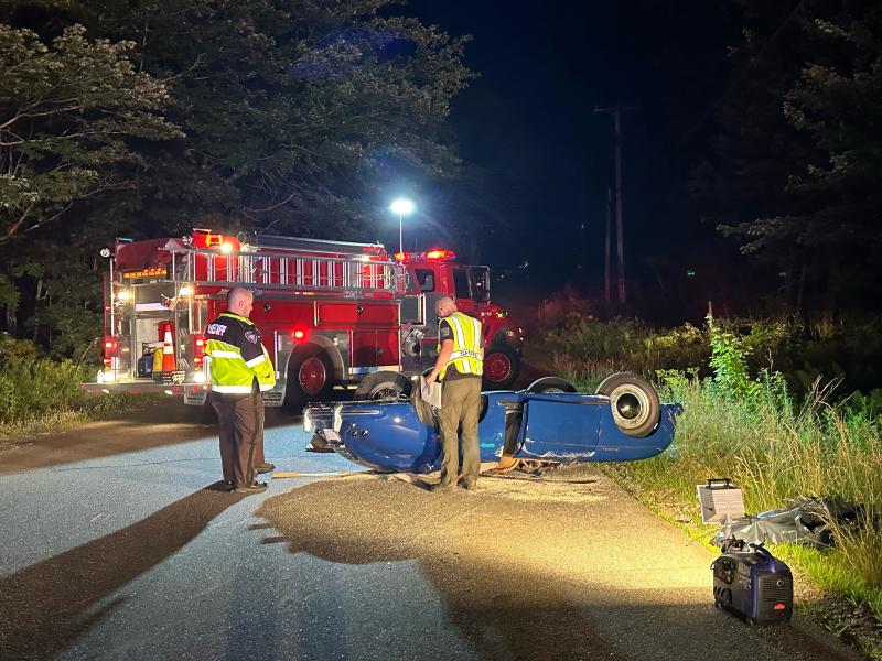 Lincoln County Sheriff’s Office accident reconstruction team members inspect the overturned Porsche on Back Narrows Road on Friday, July 19. Mark Sullivan photo