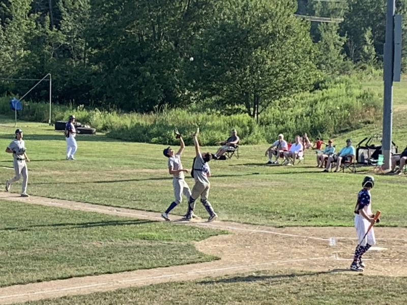 Boothbay pitcher Finn Harkins and catcher Maddox Cusumano converge on an infield pop-up July 15 versus Dirigo. BILL PEARSON/Boothbay Register