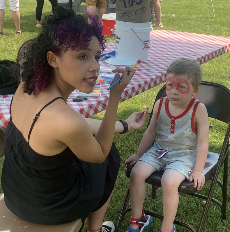 Imij Armstead, left, paints faces during the celebration. BILL PEARSON/Boothbay Register