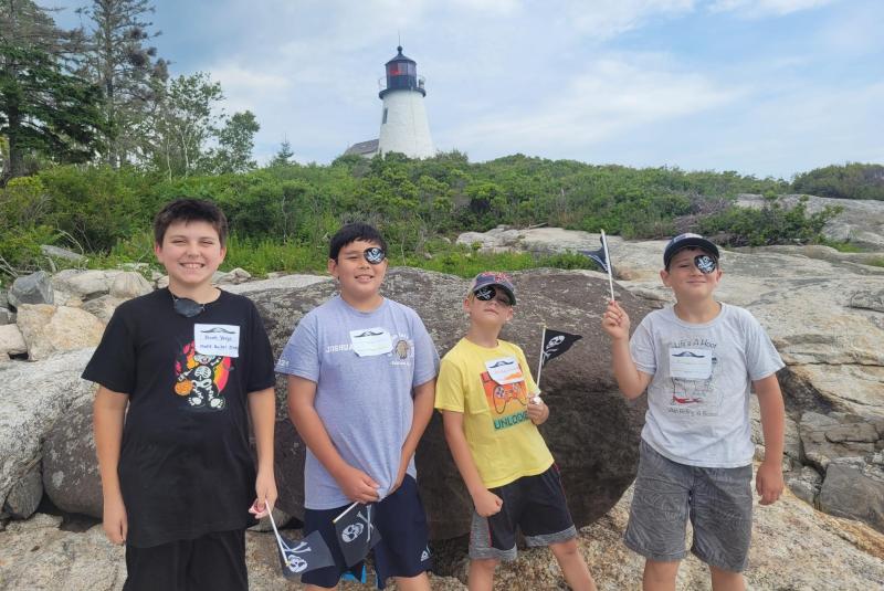 Edgecomb Eddy students with Burnt Island lighthouse in the background. From left to right, Jacob Verge, Joshua Stetson, Blake Cassidy and Harland Johnson. Courtesy of Jennifer Lassen