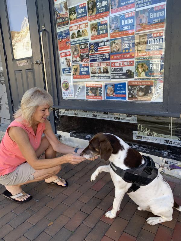 Philo, candidate for king of Wiscasset, offers a paw Aug. 30 to Laurie Winslow, a friend of his owner Cynthia Pappas. SUSAN JOHNS/Wiscasset Newspaper