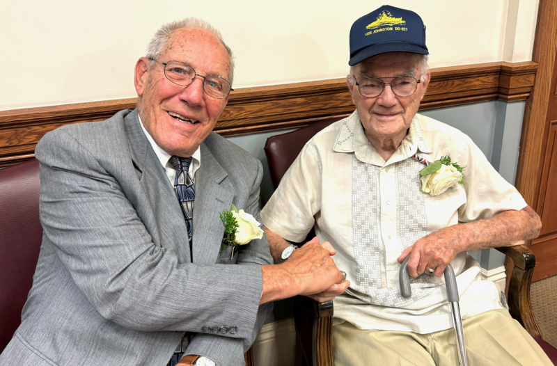 Al Sirois, left, greets a fellow Korean War veteran. Courtesy of Sarah Sherman