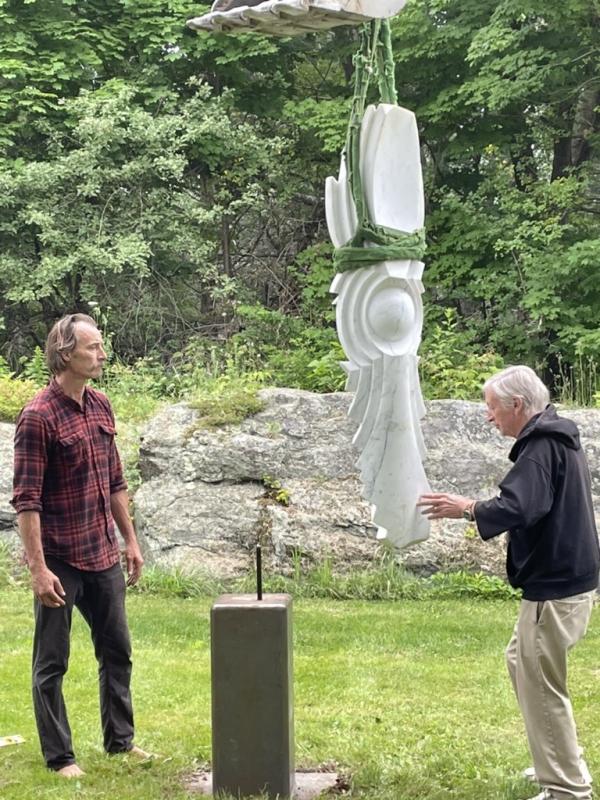 Chris Lewis, left, and Bill Royall prepare to set “Seed” on its base. Courtesy of Diana Kerr