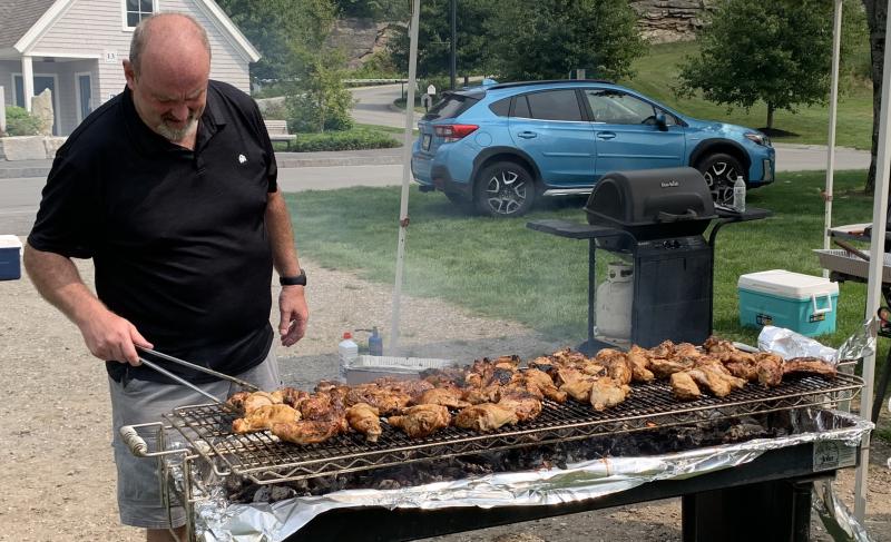 Volunteer Brad Drummond carefully watches barbecue chicken baking Aug. 17 during the annual V.E.T.S. Inc. fundraiser at Boothbay Common. BILL PEARSON/Boothbay Register