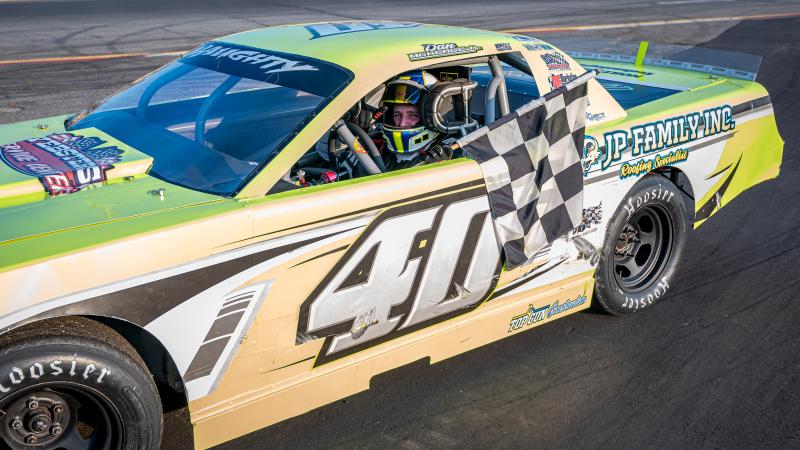 Dan McKeage Jr. collects the checkered following his Strictly Street win at Wiscasset Speedway. Courtesy of David Montgomery/Mainemmonty Media