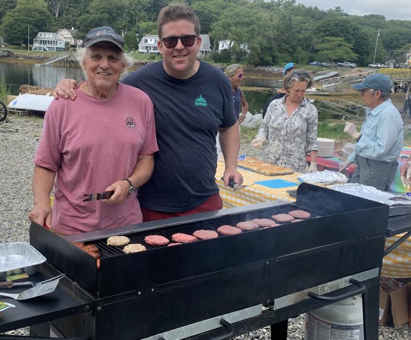Grill masters Chris Richardson, left, and Denny Whitten cooked burgers and hot dogs Aug. 16 at Boothbay Sea and Science Center “Last Day of Camp” barbecue. .BILL PEARSON/Boothbay Register
