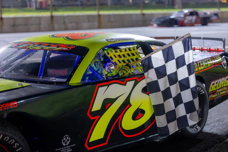 Tiger Colby collects the checkered flag after winning the Late Model 75 at Wiscasset Speedway. Jasen Dickey Photography